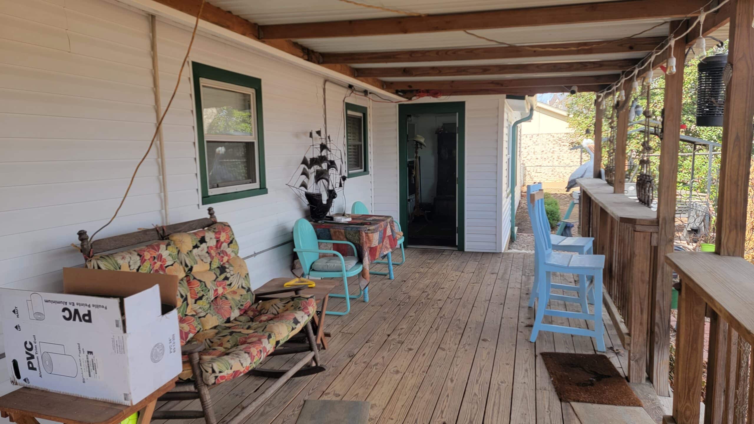 Looking at the rear porch of a country home in Burleson Texas after getting new white CraneBoard Siding installed.