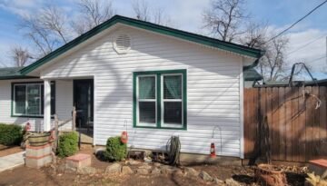 Looking at a home in Burleson, Texas with white Exterior Portfolio Siding with Grecian Green Accents and new Vistamark Vinyl Windows installed by ProTex Remodeling.