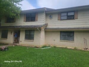 Kern Family house before photo showing how worn out their windows and siding had become.