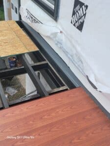 Nexan aluminum decking flashing up against the side of the house.