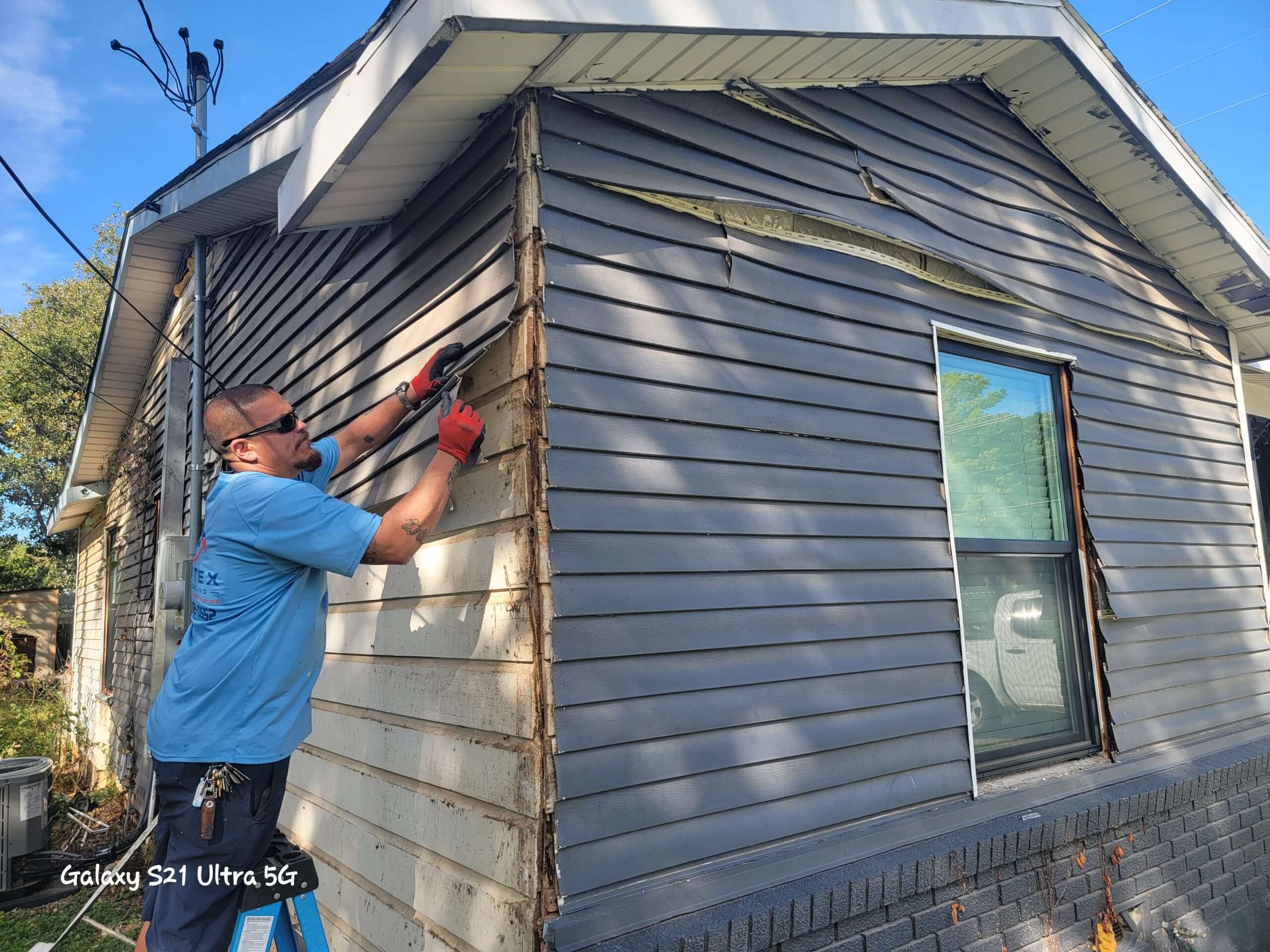 Sascha is removing old vinyl siding from a home in Hurst Texas.