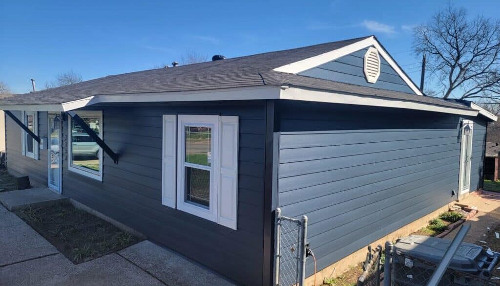 ASCEND Composite Siding by ProTex Remodeling. This is Front view of a cottage style home in Dallas Texas after getting new Ascend composite siding in Midnight Blue with White accents and Signature Elite Replacement Window System from ProTex Remodeling.
