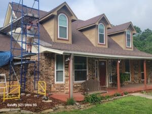 Front view of Aaron and Sascha setting up scaffolding for siding replacement in Kennedale Texas.