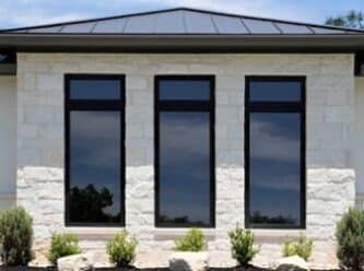 Premium, Andersen 100 Series Fibrex Window ProTex Remodeling featuring the Andersen 100 series Fibrex window system with black frames and Smart Sun Glass