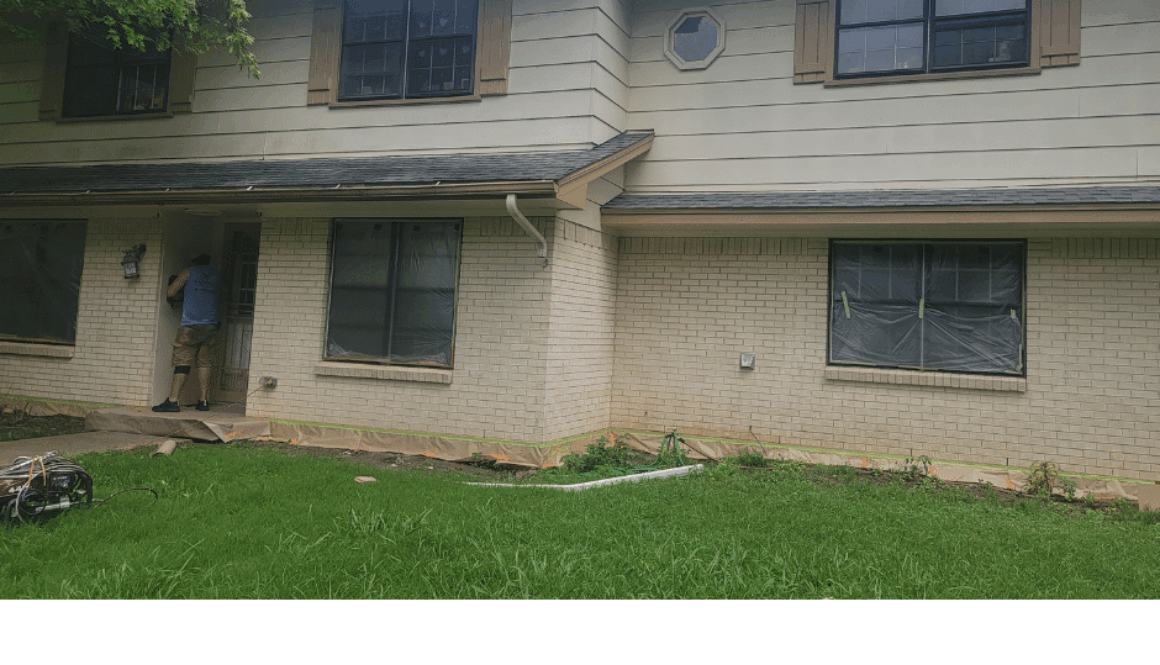 ProTex Remodeling is looking at Old Windows in a two story home that needs new replacement windows. The house has tan brick on the first floor with matching wood siding on the second floor that needs to be replaced along with the old windows. It's a bright sunny day in Texas with a light cloud cover.