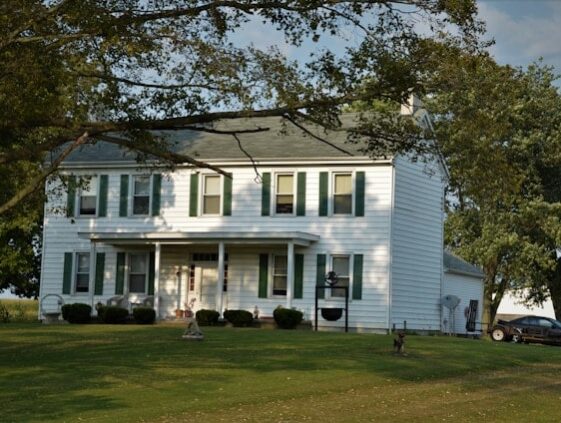 older country home with siding and windows that need to be replaced