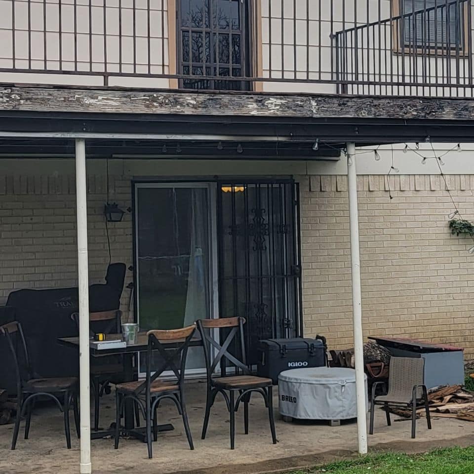 This is an old, outdated aluminum patio door with security bars on a ProTex Remodeling customer's home in Duncanville, Texas.